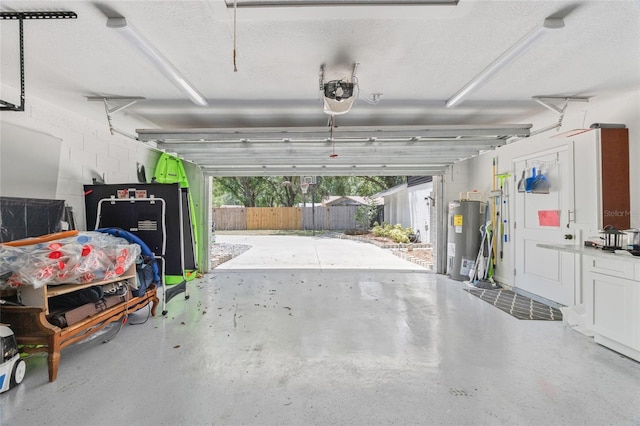 garage featuring water heater and a garage door opener