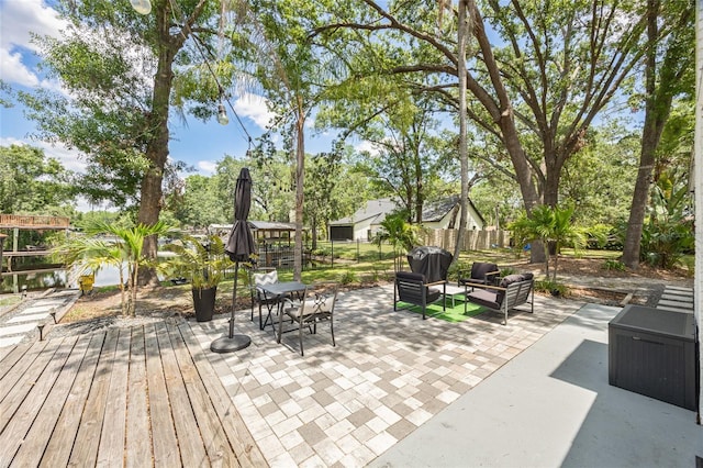 view of patio with an outdoor hangout area and fence