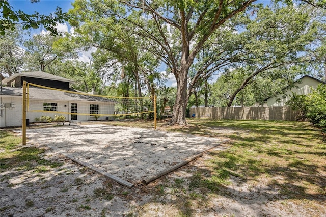 view of yard with fence and volleyball court