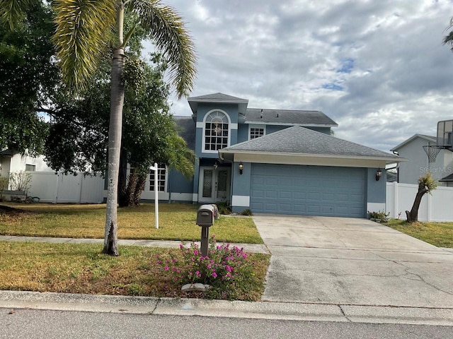 11727 Spanish Lake Dr, Tampa, FL 33635 - traditional-style home featuring fence, a front yard, stucco siding, concrete driveway, and an attached garage
