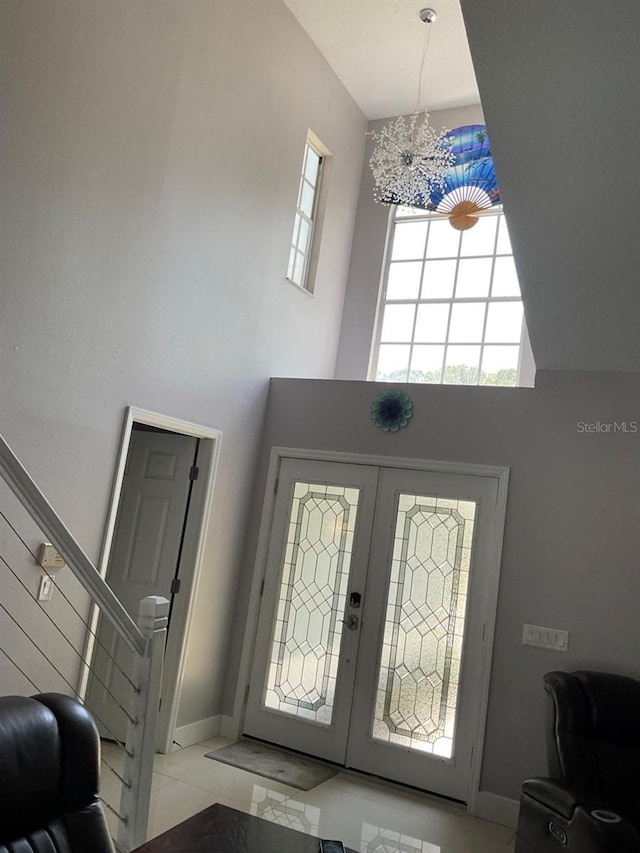 11727 Spanish Lake Dr, Tampa, FL 33635 - foyer with an inviting chandelier, french doors, stairs, and a towering ceiling
