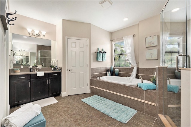 bathroom with visible vents, a bath, a shower stall, tile patterned flooring, and vanity