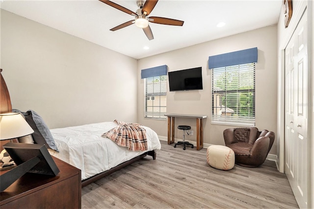 bedroom featuring a closet, recessed lighting, baseboards, ceiling fan, and wood finished floors