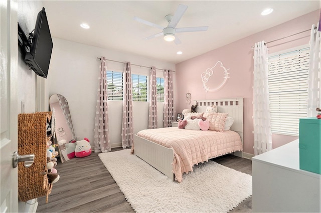 bedroom featuring wood finished floors, baseboards, and recessed lighting
