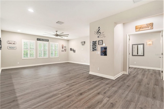 empty room with recessed lighting, baseboards, a ceiling fan, and dark wood finished floors