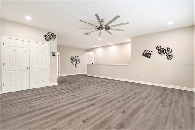 interior space with wood finished floors, a ceiling fan, and recessed lighting