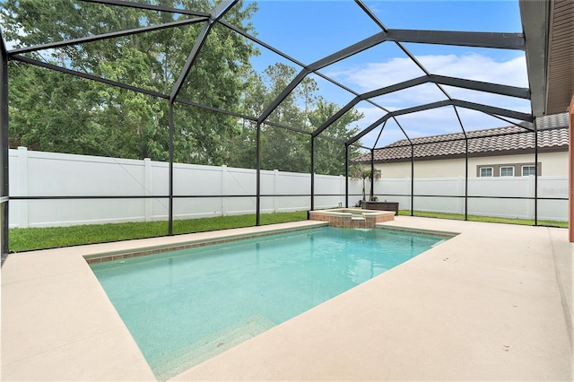 view of swimming pool featuring a pool with connected hot tub, a patio, a lanai, and a fenced backyard