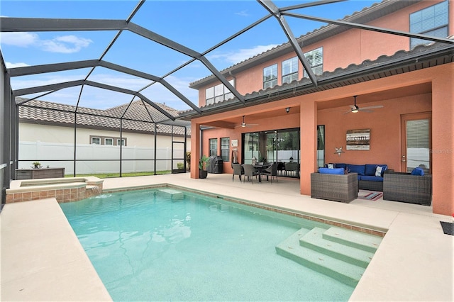 view of swimming pool with a ceiling fan, a pool with connected hot tub, an outdoor hangout area, a patio area, and glass enclosure