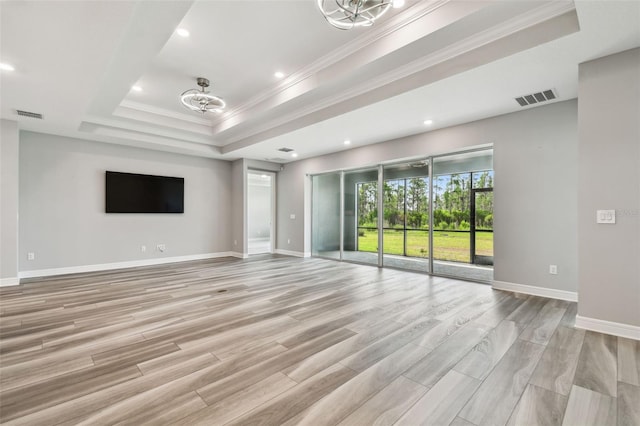5670 Shorebird Br, Land O Lakes, FL 34638 - unfurnished living room featuring a raised ceiling, crown molding, light wood-type flooring, baseboards, and recessed lighting