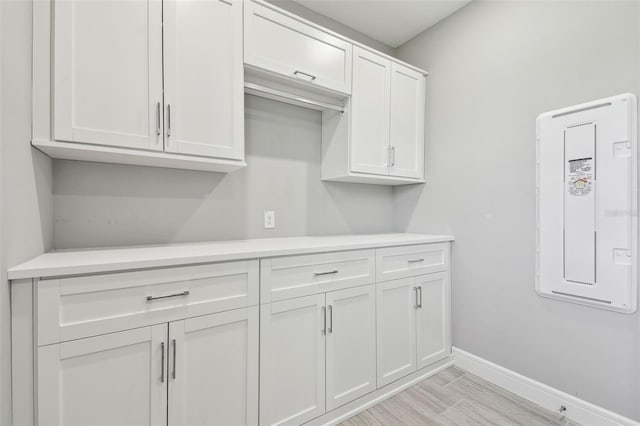 5670 Shorebird Br, Land O Lakes, FL 34638 - kitchen featuring baseboards, light countertops, white cabinetry, and light wood-type flooring