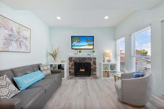 337 Rex Pl Unit G, Madeira Beach, FL 33708 - living room with baseboards, a fireplace, recessed lighting, and wood finished floors