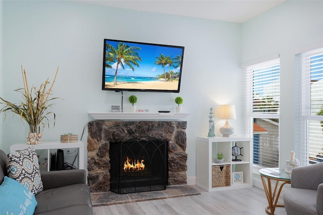 337 Rex Pl Unit G, Madeira Beach, FL 33708 - living area featuring wood finished floors and a stone fireplace