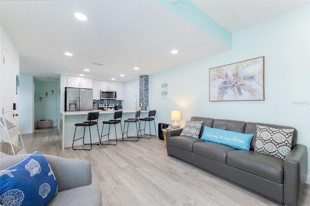 337 Rex Pl Unit G, Madeira Beach, FL 33708 - living area with light wood-type flooring, baseboards, and recessed lighting