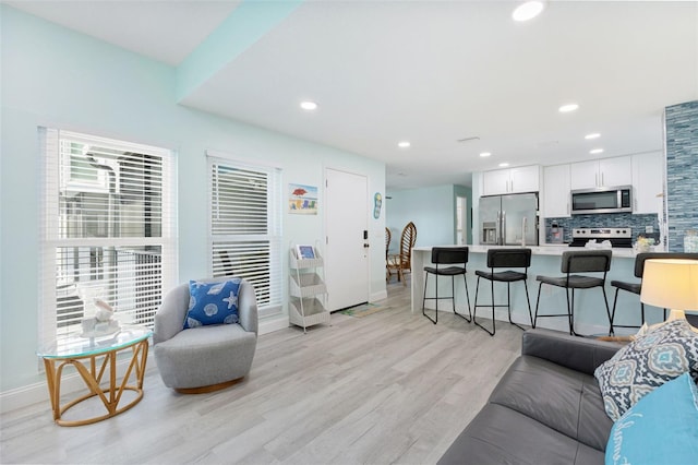 337 Rex Pl Unit G, Madeira Beach, FL 33708 - living area with light wood-style floors, baseboards, and recessed lighting