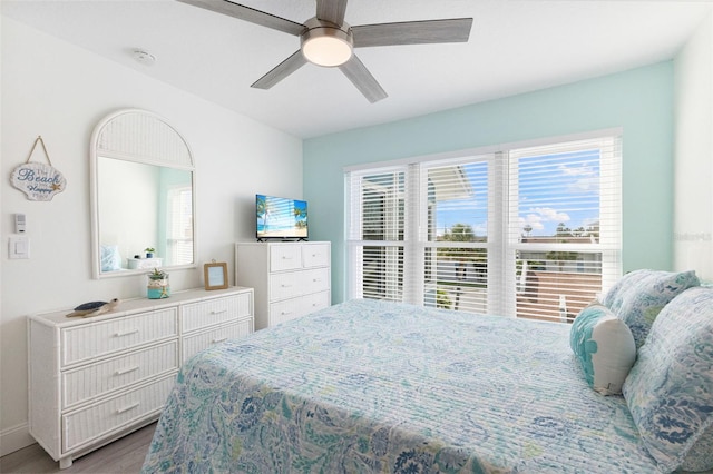 337 Rex Pl Unit G, Madeira Beach, FL 33708 - bedroom with baseboards, ceiling fan, and wood finished floors