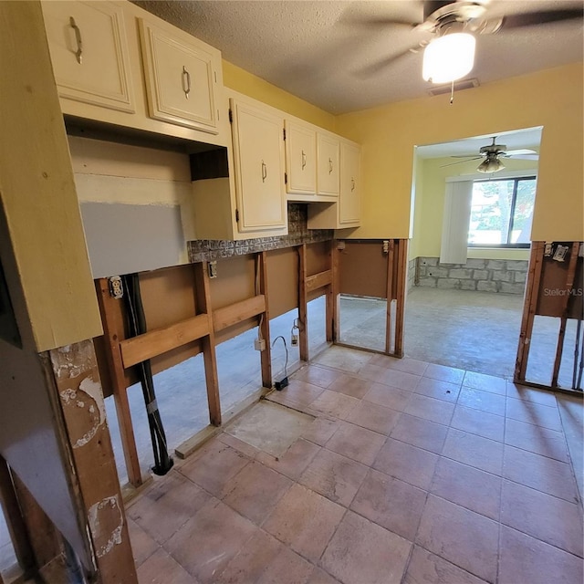 1234 11th Cir SE, Largo, FL 33771 - kitchen featuring a ceiling fan, white cabinets, and a textured ceiling