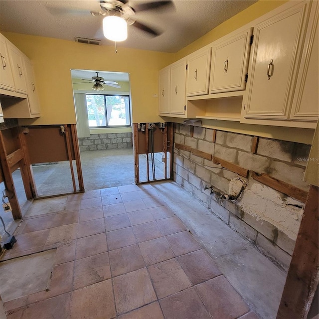 1234 11th Cir SE, Largo, FL 33771 - kitchen with ceiling fan and white cabinets