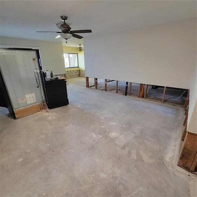 1234 11th Cir SE, Largo, FL 33771 - unfurnished living room featuring concrete floors and ceiling fan