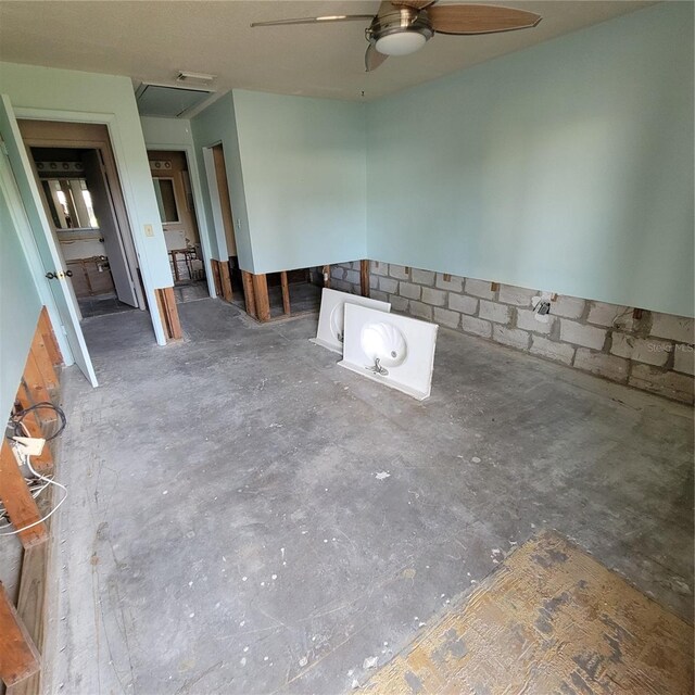 1234 11th Cir SE, Largo, FL 33771 - unfurnished room featuring a ceiling fan, attic access, and concrete flooring