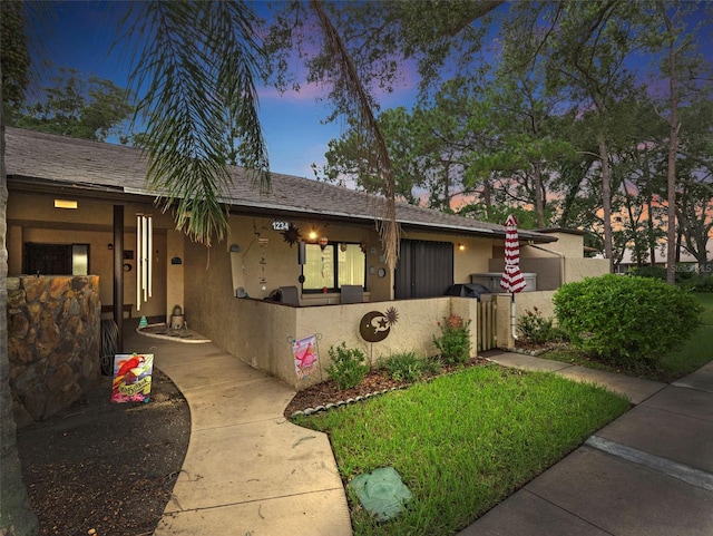 1234 11th Cir SE, Largo, FL 33771 - view of front facade with stucco siding, fence, and a gate