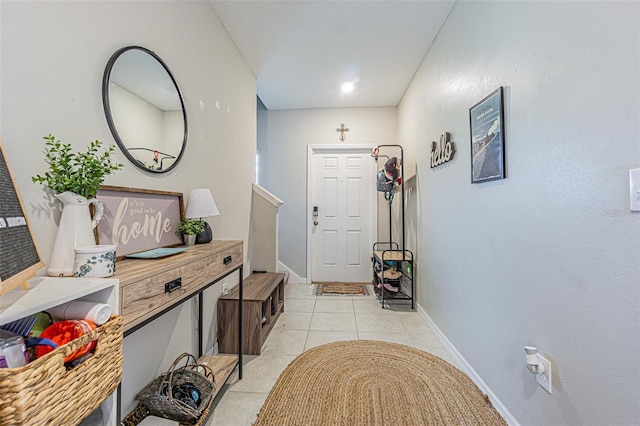 entrance foyer featuring baseboards and light tile patterned flooring