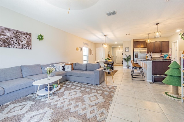 living area with visible vents and light tile patterned flooring
