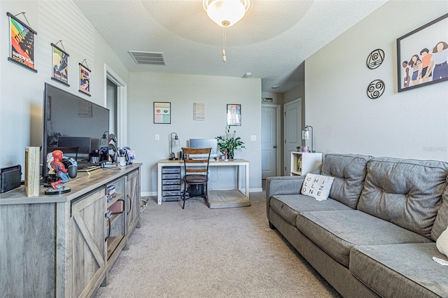 living area with visible vents, baseboards, and light carpet