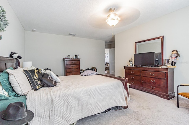 bedroom featuring light colored carpet, ceiling fan, and visible vents