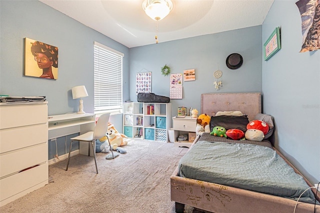 carpeted bedroom featuring baseboards
