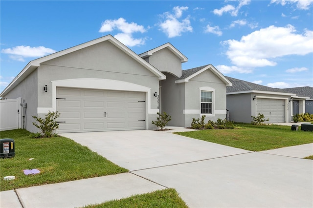 single story home with a garage, stucco siding, and concrete driveway