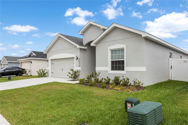 view of front facade featuring concrete driveway, an attached garage, a front lawn, and stucco siding