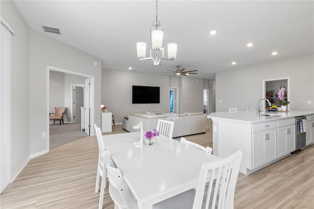 dining space with a chandelier, light wood-style flooring, ceiling fan, recessed lighting, and baseboards