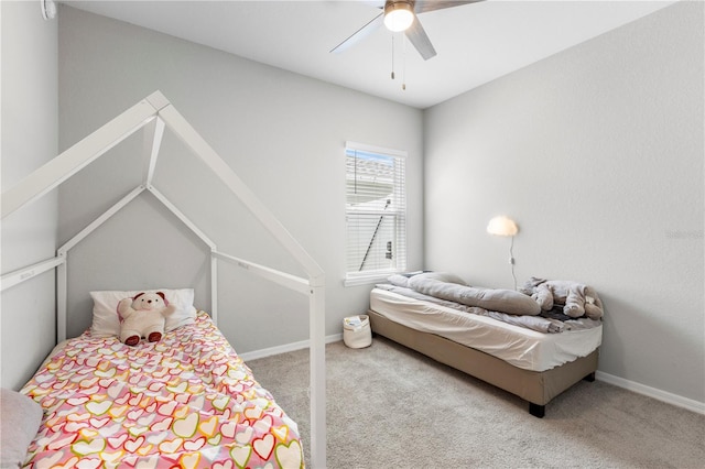 carpeted bedroom featuring ceiling fan and baseboards