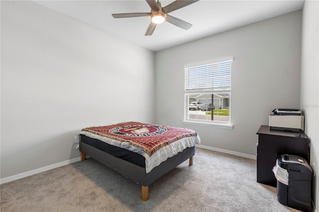 carpeted bedroom featuring baseboards and ceiling fan
