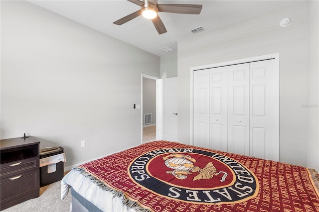 bedroom with a closet, lofted ceiling, baseboards, ceiling fan, and light carpet