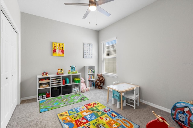 rec room with carpet flooring, a ceiling fan, and baseboards
