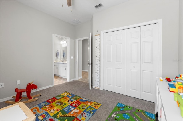 playroom with carpet floors, a ceiling fan, and baseboards