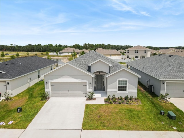 view of front facade with a garage, concrete driveway, a residential view, and a front lawn