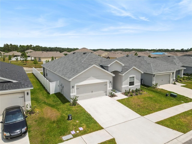 ranch-style house featuring stucco siding, driveway, a residential view, and an attached garage