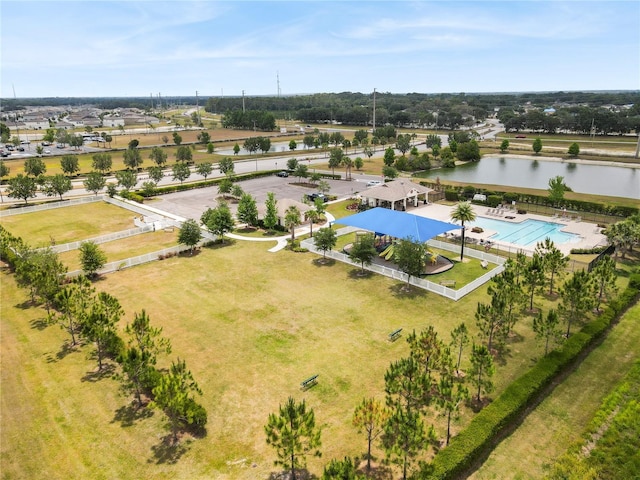 aerial view of a pool area and a nearby body of water