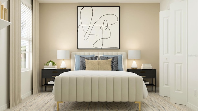 bedroom with baseboards and light colored carpet
