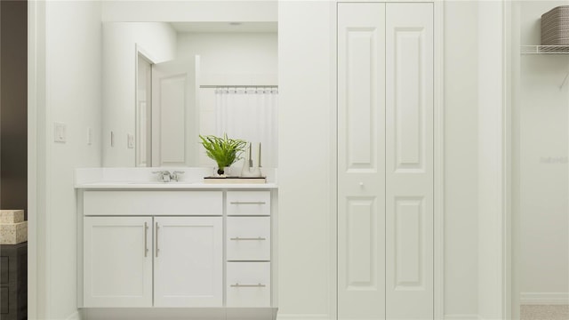 bathroom featuring a closet, baseboards, and vanity
