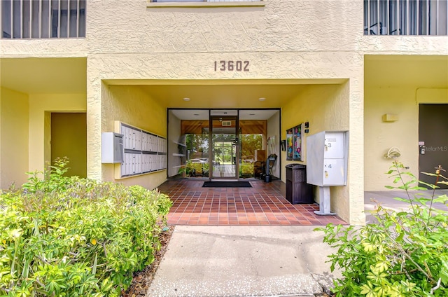 property entrance with stucco siding