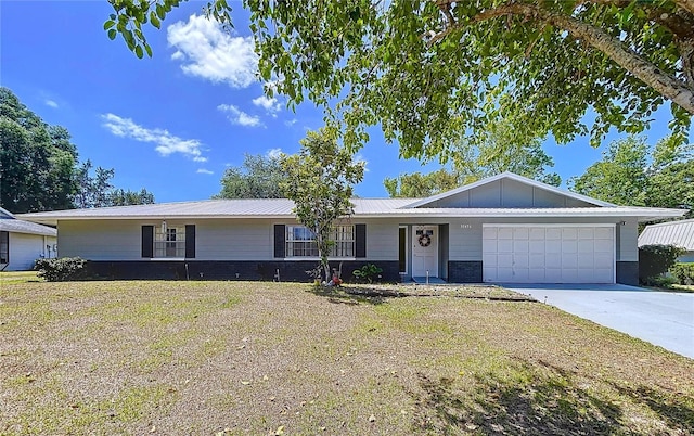 single story home featuring concrete driveway, an attached garage, and board and batten siding