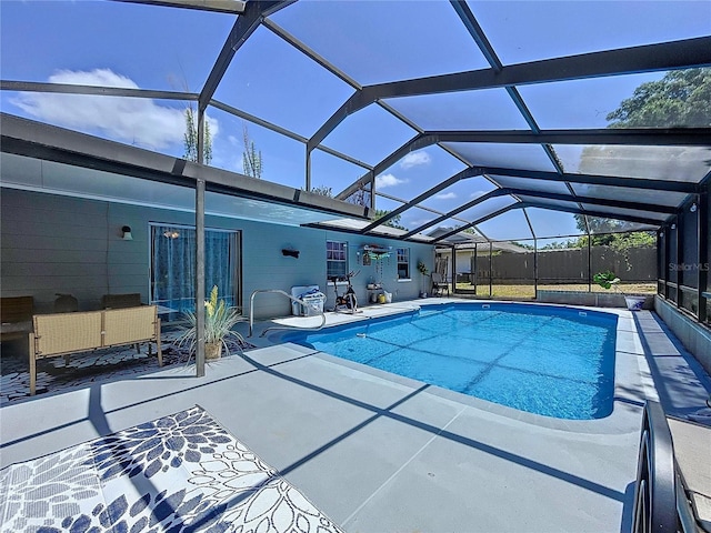 pool featuring a patio area, a lanai, and fence