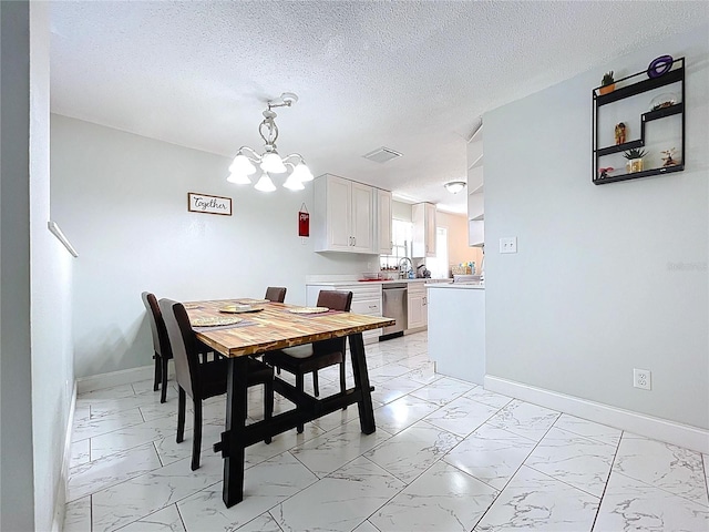 dining room with baseboards, marble finish floor, and a notable chandelier