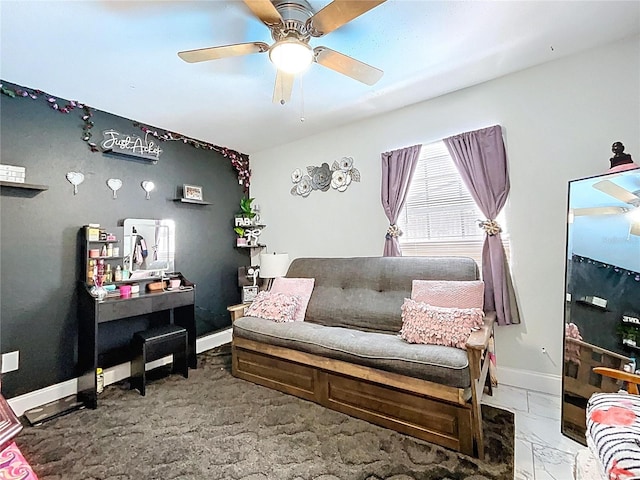 living room with baseboards and a ceiling fan