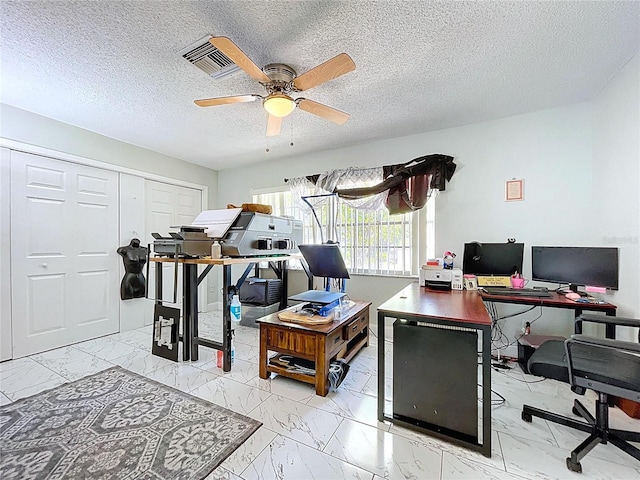home office with marble finish floor, visible vents, ceiling fan, and a textured ceiling