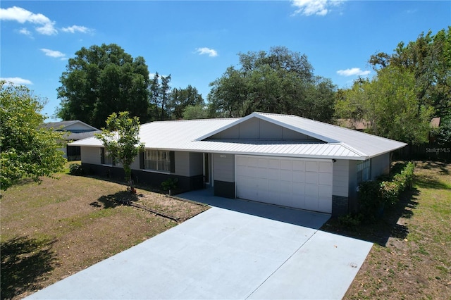 ranch-style home with concrete driveway, an attached garage, and board and batten siding