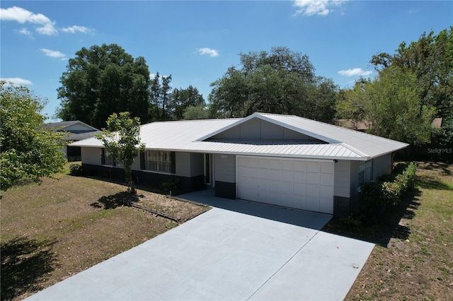 ranch-style home featuring an attached garage, board and batten siding, and driveway